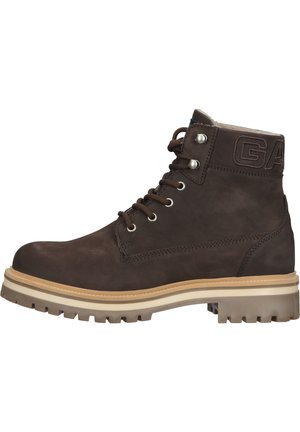 Brown leather boots with a high ankle design. Features a textured surface, round laces, and a rugged, patterned rubber sole. Accented with logo.