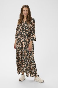 Maxi dress in dark green with pink floral and leopard print. Features a V-neckline and three-quarter sleeves, worn with light-colored sneakers.