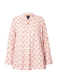 Blusa leggera a maniche lunghe con scollo a V, caratterizzata da un motivo geometrico rosso e bianco su sfondo crema. Tessuto morbido e vestibilità rilassata.