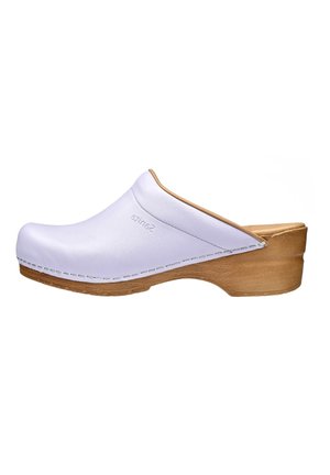 White clogs made of smooth, durable material with a wooden heel. Features a rounded toe, stitched detailing, and a backless design.