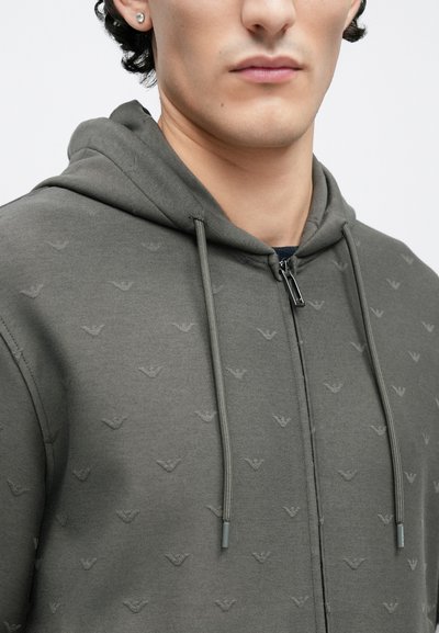 Γκρι φούτερ με φερμουάρ, με υφή που απεικονίζει μικρά λογότυπα, κουκούλα με κορδόνι και λεία υφασμάτινη υφή.