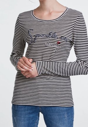 Langärmliges gestreiftes Hemd in Schwarz und Creme mit besticktem Text und Pailletten. Baumwollmischgewebe, Rundhalsausschnitt. Lässiger Schnitt.