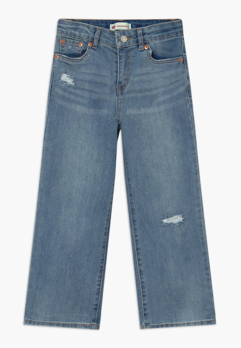 Vaaleansinisiä farkkuja, leikattu leveä lahje, jossa on keski-nostettu vyötärö, etupuolella kulutustekijöitä, viisi taskua ja kuparinväriset yksityiskohdat.