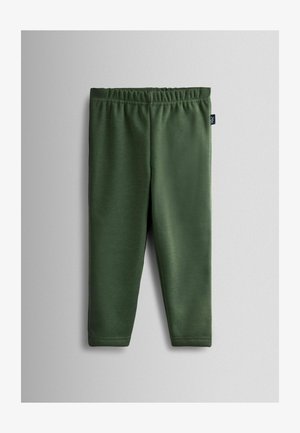 Zöld leggings, puha, rugalmas anyagból készült. Rugalmas derékkal és sima textúrával rendelkezik. Nincsenek látható minták vagy fémrészek.