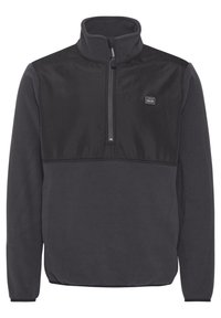 Veste polaire à col zippé mi-haut en gris foncé. Elle présente un panneau poitrine noir contrastant lisse et un écusson avec le logo sur le côté gauche.