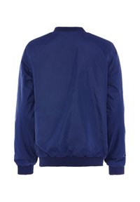 Tamsiai mėlynas bombonešis, pagamintas iš sklandaus, lengvo audinio, su guma apdirbtais apykakle ir rankogaliais, elastine juosmeniu ir be matomų ženklų.