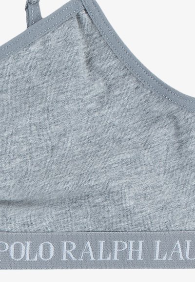 Svetlo siva bralette iz mehkega blaga. Ima nastavljive naramnice in rebrast pas s pisanjem "POLO RALPH LAUREN" v beli barvi.