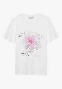 Hvit bomull t-skjorte med et pink blomsterdesign og teksten "DON'T WORRY BE HAPPY" i lyse pink, plassert mot blomsterdesignet.