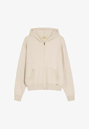 Beżowa bluza z kapturem na zamek, z przednimi kieszeniami, ściągaczami na rękawach i dole, o luźnym kroju z przymocowanym kapturem.