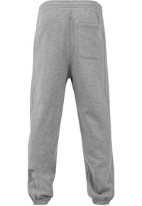 Graue Jogginghosen aus weichem Material mit elastischem Bund, einer Gesäßtasche und elastischen Bündchen an den Knöcheln.