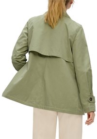 Light green jacket with a layered back design, long sleeves, and buttoned cuffs. Made from a smooth fabric, featuring a relaxed fit.