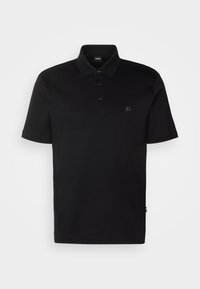 Polo noir en coton, doté d'un col, d’une patte à trois boutons et d'un petit logo sur la poitrine. Manches courtes et ourlet droit.