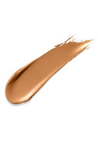 Creamy beige liquid foundation spread in a smooth stroke with a slight sheen, featuring a soft texture and a blendable finish on a white background.