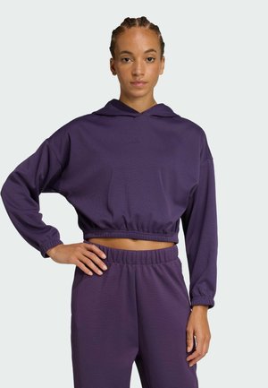 Felpa corta e pantaloni coordinati in tessuto viola testurizzato. La felpa presenta un cappuccio e un orlo elasticizzato, con maniche lunghe e morbide.