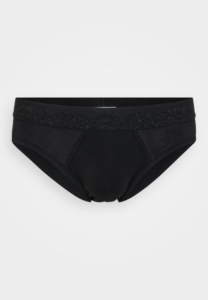 Short noir en coton avec une texture lisse, doté d'une large ceinture élastique ornée d'un design imprimé brillant.