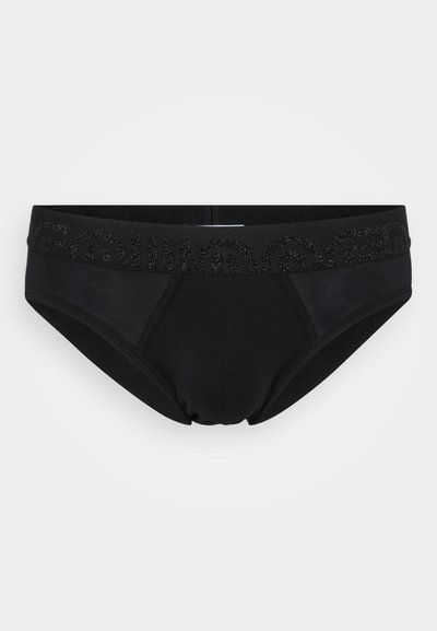 Schwarze Baumwollshorts mit glatter Textur, ausgestattet mit einem breiten elastischen Bund, der mit einem glänzenden Druckdesign verziert ist.