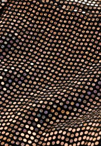 Tessuto nero coperto di piccole paillettes rotonde, luminose, nei toni dell'oro e del rosa, che creano una superficie testurizzata e riflettente con un motivo ritmico.