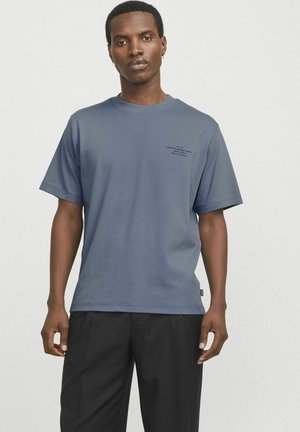 Short-sleeve, crew-neck t-shirt in dark blue fabric, featuring a small black text print on the left chest and relaxed fit.