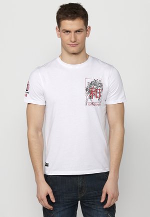 White cotton t-shirt featuring a black and red graphic design with intricate details, short sleeves, and a crew neck.