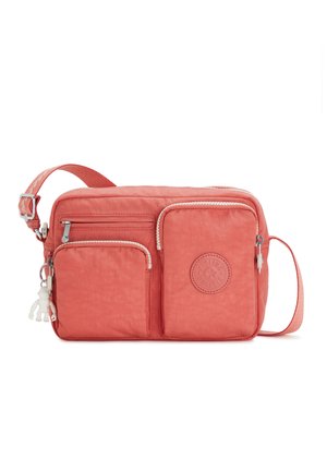 Coral crossbody bag with multiple zippered pockets, textured fabric, adjustable strap, and a logo patch. Includes a playful charm.