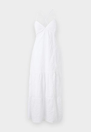 Rochie albă de vară cu bretele subțiri în cruce, cu un corset ajustat și un fusta stratificată și fluidă. Fabricată dintr-un material ușor, cu o textură subtilă.