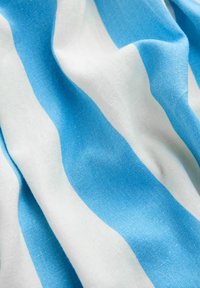 Kerge kangas, millel on vahelduvad laiad triibud erksinises ja valges, millel on sile tekstuur ja pehme lange.