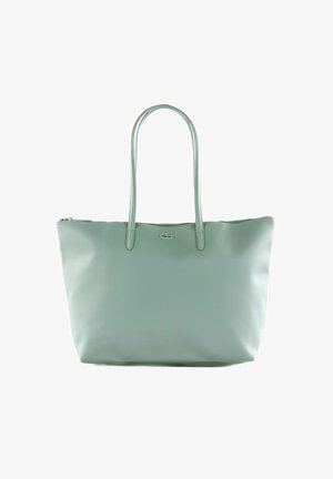 Light green leather tote bag with two long handles, a zip closure, and a small silver crocodile logo on the front center.