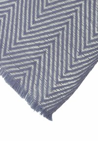 Herringbone patterned fabric in light purple and white, featuring a soft texture and frayed edges. Ideal for cozy settings and decor.