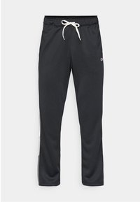 Musta urheiluhousut, jotka on valmistettu sileästä kankaasta. Housuissa on joustava vyötärö, jossa on valkoinen naru ja sivupaneelikorostukset. Logot vyötäröllä.