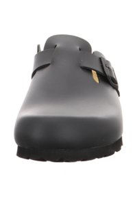 Black clogs with a smooth, matte finish. Design features a round toe, a side buckle, and a textured rubber sole for grip.