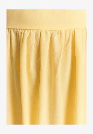 Gul stofnederdel med en tekstureret, letvægtsmateriale. Har et samlet design og en elastisk talje for en afslappet pasform.