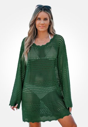 Groene gehaakte overgooier met een losse pasvorm, lange mouwen en een golvende zoom. Voorzien van grote open breipatronen voor ademend vermogen.