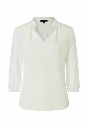 White blouse with a V-neckline, three-quarter sleeves, and gathered detail at the shoulders. Smooth texture and slightly curved hem.