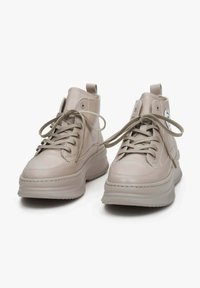 Two beige high-top sneakers made from smooth synthetic material, featuring laces, a textured rubber sole, and a circular logo accent.