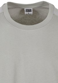 Világosszürke póló, kerek nyakkivágással, rövid ujjakkal és sima felülettel. A címke szerint "URBAN CLASSICS", M-es méret, Bangladesben készült.