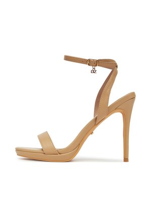 Beżowy sandał na wysokim obcasie z platformą, paskiem wokół kostki i klamrą. Charakteryzuje się gładką skórzaną fakturą oraz smukłym obcasem typu szpilka.