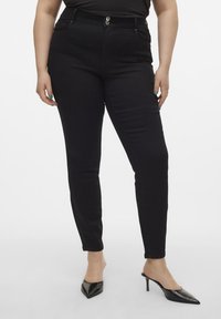 Svart skinny jeans med hög midja, med en stängning med två knappar, bältesöglor och framfickor. Slät denimtyg och åtsittande silhuett.
