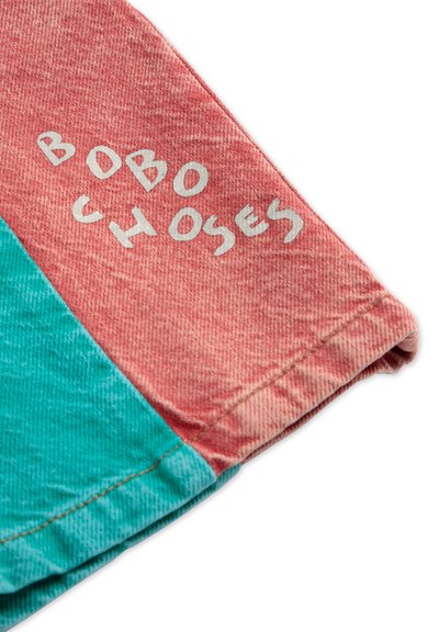 Tissu en bloc de couleurs présentant un design corail et teal. Le texte "BOBO CHOSES" est imprimé en blanc sur la section corail.