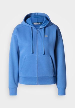 Svetlomodrá mikina na zips z bavlneného zmesi, s klokaním vreckom, nastaviteľnou kapucňou so šnúrkou a rebrovanými manžetami. Malé logo.