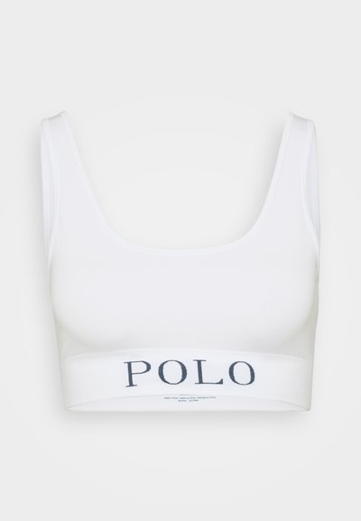 White sports bra with wide shoulder straps and a band featuring the word "POLO" in dark blue. Smooth texture and fitted design.