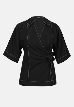Black wrap top featuring short sleeves, a tied detail at the waist, and contrasting white stitching along the seams and collar.