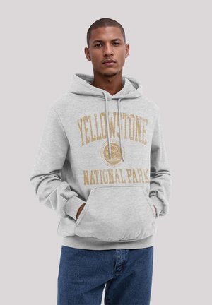 Gray sweatshirt with a front pocket, featuring yellowed text that reads "YELLOWSTONE NATIONAL PARK" in a vintage style.