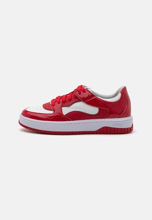 Sneaker in pelle rossa e bianca con finitura lucida, punta arrotondata, chiusura con lacci, collo imbottito e suola in gomma testurizzata.
