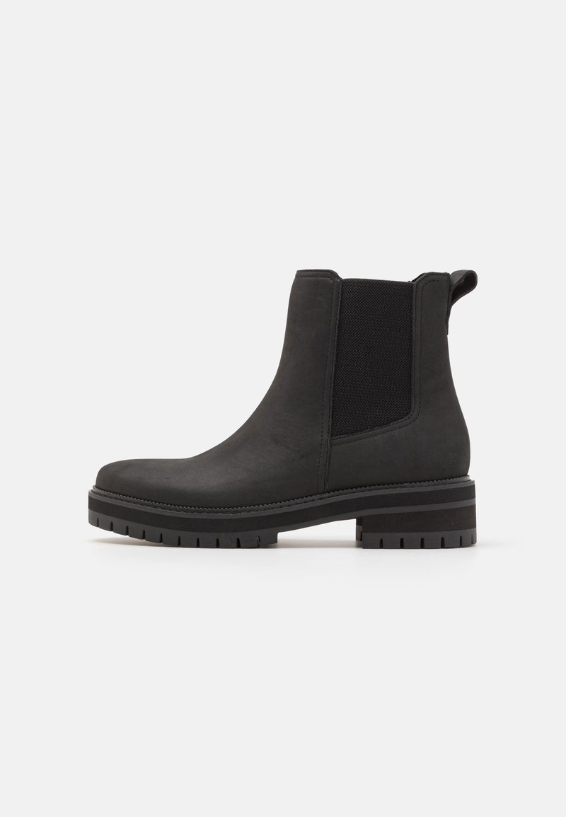 Botas negras hasta el tobillo con un exterior suave similar al cuero, paneles laterales elásticos y una suela de goma texturizada para mayor tracción. Diseño de puntera redondeada.