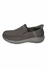 Gray slip-on shoes with a textured fabric upper and smooth gray rubber sole. Features elastic side panels for easy wear and a subtle logo detail.