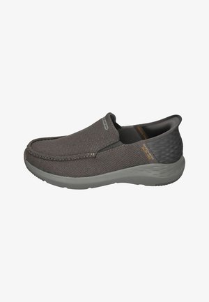 Gray slip-on shoes with a textured fabric upper and smooth gray rubber sole. Features elastic side panels for easy wear and a subtle logo detail.