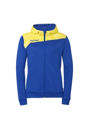 Blå lynlåstrøje med hætte og gul geometrisk mønster på skuldre og hætte, med "Kempa" logo på venstre bryst.