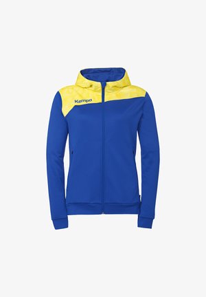 Veste à capuche bleue à fermeture éclair avec un motif géométrique jaune sur les épaules et la capuche, arborant le logo "Kempa" sur la poitrine gauche.
