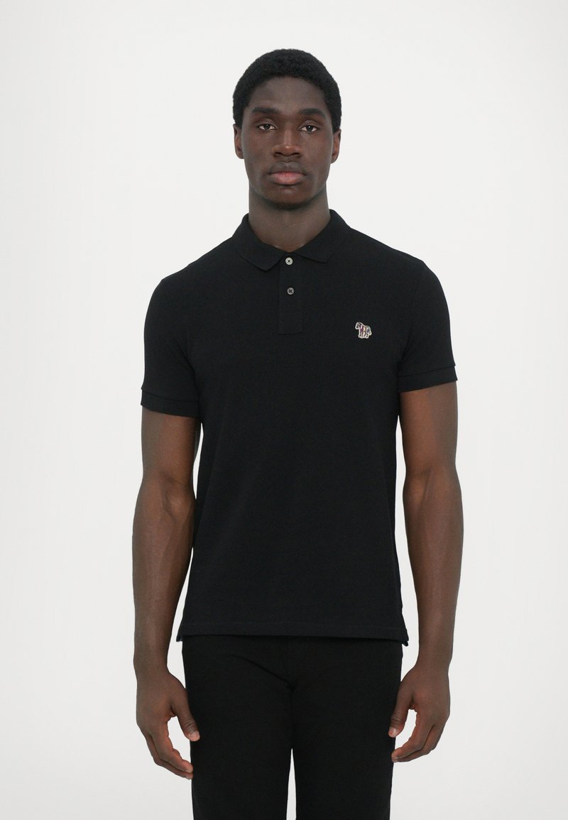 Black polo shirt with a collared neckline, three buttons, and a small logo on the left chest. Short sleeves and a fitted design.