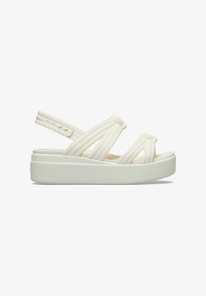 White platform sandal with padded straps and adjustable back strap, featuring a thick sole and simple modern design.